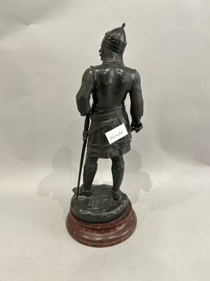 an image of a statue of a man in armor with a sword