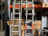 several ladders are stacked on top of each other in a warehouse