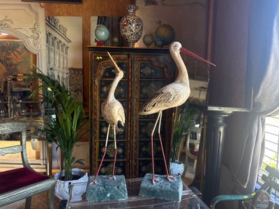 two birds that are standing on top of a table