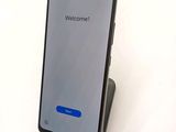 the back of a black samsung s9 with a welcome screen on it