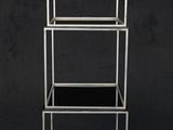 a white metal shelf with three shelves on top of it