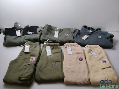 several pairs of men ' s pants are lined up on a table