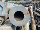 a pile of metal pipes and pipes in a junkyard