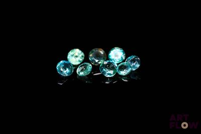 a close up of a group of blue diamonds on a black surface