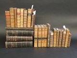 several old books stacked on top of each other on a table