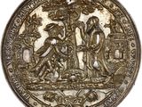 un gros plan d'une pièce d'argent sur laquelle figurent des personnages