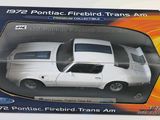 a box with a white car in it on a table