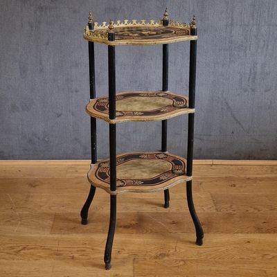 an image of a three tiered table on a wooden floor