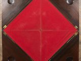 an overhead view of a wooden table with red cloth on it