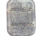 a clear glass container with a metal handle