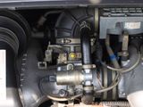 a close up of a car engine with a hose connected to it
