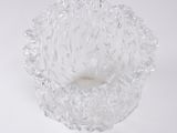 a glass bowl that is sitting on a white surface