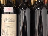 several bottles of wine are lined up on a shelf in a store