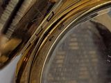 a close up of a gold clock with a clock face