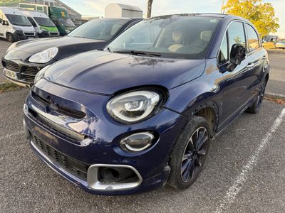 the front end of a blue fiat car parked in a parking lot