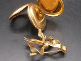 a gold ring that has been broken on the table