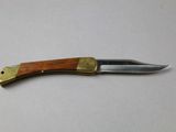 a knife with a wooden handle on a table