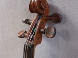 a close up of a violin on a stand
