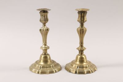 pair of antique brass candlesticks on a white background