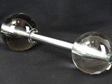 a glass wine glass with a metal handle on a black background
