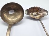two spoons that are next to each other on a table