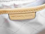 the inside of a white bag with a tan leather handle