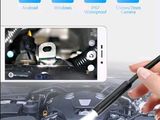 a picture of someone using a cell phone to fix a car engine