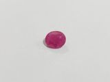 a pink oval stone on a white surface