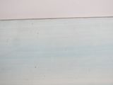 a man riding a surfboard on the beach in the ocean