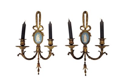 pair of antique wall sconces with a picture of a woman and two candles