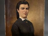 portrait of a woman in a black dress and white collared shirt
