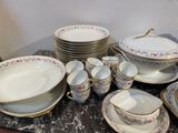 a lot of plates and bowls on the table