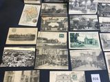 several old black and white photographs of people and buildings on a table