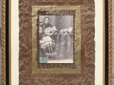 an old photo of a woman and child sitting in a chair