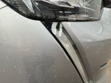 a close up of a car ' s headlight on the side of the road