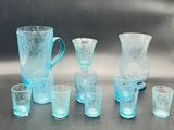 a lot of blue glass items sitting on a table