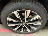 the tire of a car with a black rim and white spokes