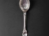 a close up of a spoon on a table with a black background