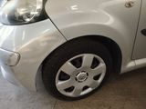 a small white car parked in a garage