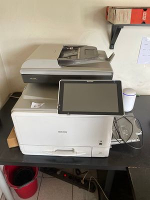 a printer sitting on top of a desk next to a printer