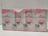 quatre boîtes d'aliments pour chatons Royal Canin posées sur une table