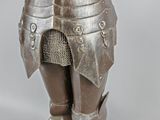a statue of a man in armor holding a knife