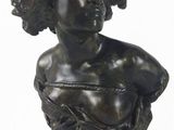une image représentant un petit buste en bronze d'une femme aux cheveux bouclés