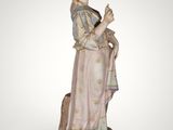 an image of a statue of a woman holding a bird