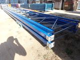 a close up of a blue metal structure on a dirt ground