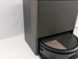 a black box with a brown lid on a white surface