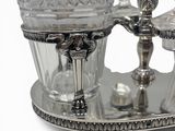 a silver plate with a glass on top of it