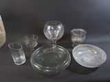 a lot of glassware on a table with a black background