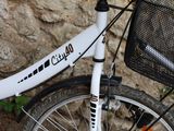 a white bicycle with a basket on the back of it