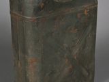 an old metal canister with a tag on it
